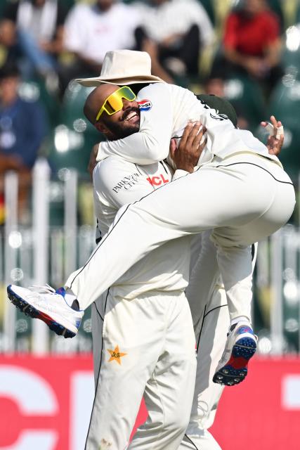 Pakistan's Sajid Khan (L) celebrates with teammate Salman Agha after taking the wicket of South Africa's captain Aiden Markram during the second day of the second Test cricket match between Pakistan and South Africa at the Rawalpindi Cricket Stadium in Rawalpindi on October 21, 2025. (Photo by Aamir QURESHI / AFP)