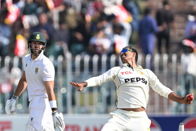 Pakistan's Noman Ali (R) bowls as South Africa's captain Aiden Markram watches during the second day of the second Test cricket match between Pakistan and South Africa at the Rawalpindi Cricket Stadium in Rawalpindi on October 21, 2025. (Photo by Aamir QURESHI / AFP)