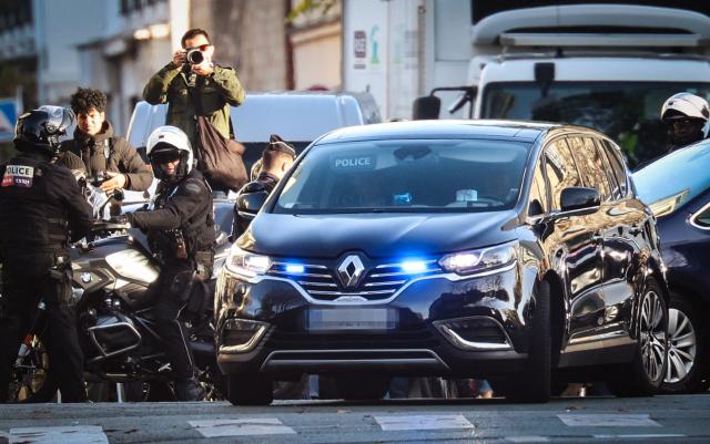 France's former president Nicolas Sarkozy arrives aboard a police vehicle at La Sante Prison for incarceration on a five-year prison sentence after being convicted of criminal conspiracy over a plan for late Libyan dictator Moamer Kadhafi to fund his 2007 electoral campaign, in Paris, on October 21, 2025. Nicolas Sarkozy, who has faced a flurry of legal woes since losing re-election in 2012, is to be jailed on October 21, 2025, over a scheme to acquire Libyan funding for his successful 2007 presidential run, becoming the first former head of a European Union country to serve time behind bars. The former French right-wing leader has appealed the verdict and denounced an "injustice". (Photo by Alain JOCARD / AFP)