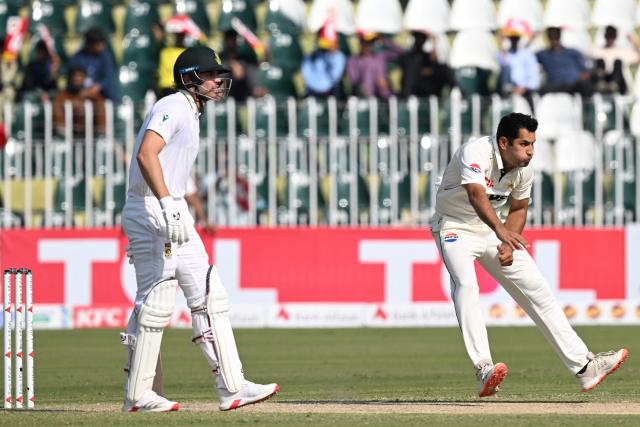 Pakistan's Asif Afridi (R) bowls as South Africa's Tristan Stubbs watches during the second day of the second Test cricket match between Pakistan and South Africa at the Rawalpindi Cricket Stadium in Rawalpindi on October 21, 2025. (Photo by Aamir QURESHI / AFP)