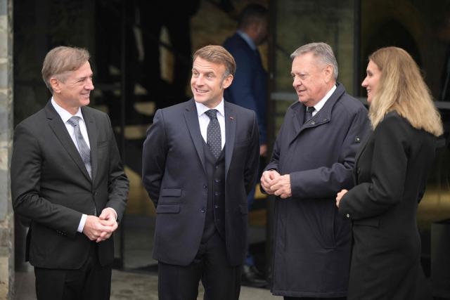 France's President Emmanuel Macron (C), Slovenia's Prime Minister Robert Golob (L) and Ljubljana's mayor Zoran Jankovic talk as they arrive ahead of Golob and Macron to hold a joint press conference and the signing of agreements at Ljubljana's Castle as part of Macron's visit to Slovenia on October 21, 2025. (Photo by Jure Makovec / AFP)