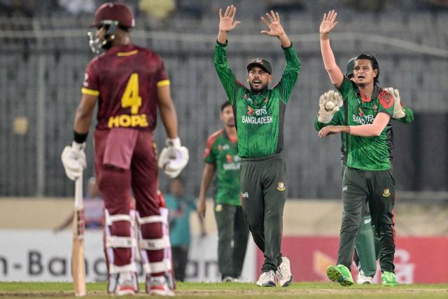 Bangladesh's players successfully appeal for the wicket of West Indies' Roston Chase during the second one-day international (ODI) cricket match between Bangladesh and West Indies at the Sher-e-Bangla National Cricket Stadium in Dhaka on October 21, 2025. (Photo by Munir UZ ZAMAN / AFP)