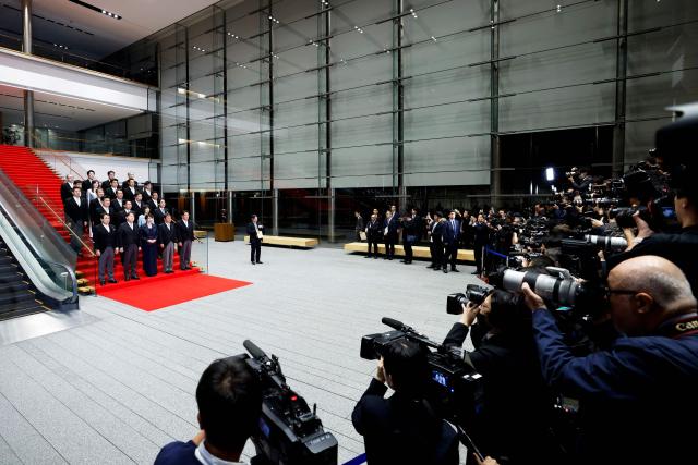 Japan's new Prime Minister Sanae Takaichi (C, front row) poses during a photo session with members of her cabinet at the prime minister's office in Tokyo on October 21, 2025. (Photo by Kiyoshi Ota / POOL / AFP)