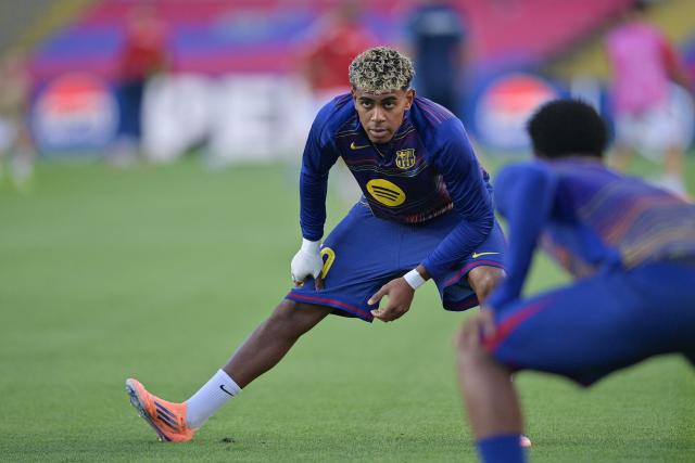 Barcelona's Spanish forward #10 Lamine Yamal stretches before the UEFA Champions League league phase match-day 3 football match between FC Barcelona and Olympiakos FC at Estadi Olimpic Lluis Companys in Barcelona on October 21, 2025. (Photo by MANAURE QUINTERO / AFP)