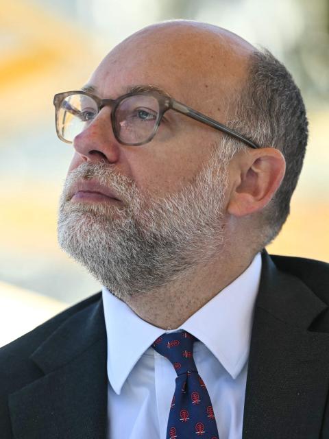 Director of the Office of Management and Budget (OMB) Russell Vought listens as President Donald Trump speaks at a "Rose Garden Club" lunch in the Rose Garden of the White House in Washington, DC, on October 21, 2025. (Photo by ANDREW CABALLERO-REYNOLDS / AFP)