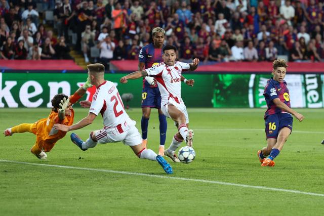 Barcelona's Spanish midfielder #16 Fermin Lopez (R) scores their first goal during the UEFA Champions League league phase match-day 3 football match between FC Barcelona and Olympiakos FC at Estadi Olimpic Lluis Companys in Barcelona on October 21, 2025. (Photo by Josep LAGO / AFP)
