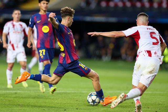 Barcelona's Spanish midfielder #16 Fermin Lopez scores their secong goal during the UEFA Champions League league phase match-day 3 football match between FC Barcelona and Olympiakos FC at Estadi Olimpic Lluis Companys in Barcelona on October 21, 2025. (Photo by Josep LAGO / AFP)