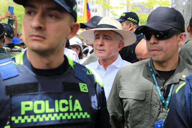 (FILES) Colombia's former president (2002-2010) Alvaro Uribe (C) participates in the so-called "Silent March" to show support for the health of Senator Miguel Uribe Turbay and to call for peace for the country in Medellin, Colombia, on June 15, 2025. A Colombian court on October 21, 2025, overturned the witness tampering conviction of influential ex-president Alvaro Uribe, who had been sentenced to 12 years' house arrest in a decision condemned by the United States. The 73-year-old, who led a relentless military campaign against drug cartels and leftist guerillas as president from 2002 to 2010, had been found guilty of asking right-wing paramilitaries to lie about their alleged links to him. (Photo by JAIME SALDARRIAGA / AFP)