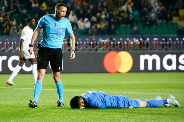 Kairat Almaty's Kazakh goalkeeper #77 Temirlan Anarbekov reacts lying on the pitch during the UEFA Champions League football match between Kairat Almaty and Pafos at the Almaty Ortalyk stadion in Almaty on October 21, 2025. (Photo by Ruslan PRYANIKOV / AFP)