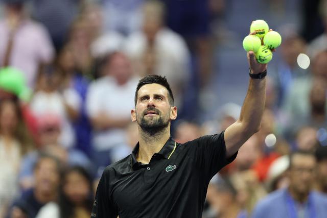(FILES) Serbia's Novak Djokovic prepares to throw signed tennis balls to fans after winning his men's singles first round tennis match against USA's Learner Tien on day one of the US Open tennis tournament at the USTA Billie Jean King National Tennis Center in New York City, on August 24, 2025. Tennisman Novak Djokovic has announced his withdrawal from the Paris Masters 1000 on Instagram on October 21, 2025. (Photo by CHARLY TRIBALLEAU / AFP)