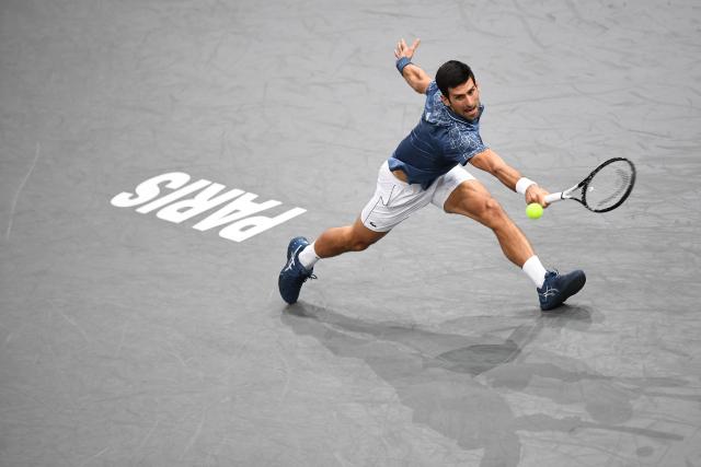 TOPSHOT - (FILES) Serbia's Novak Djokovic returns the ball to Croatia's Marin Cilic during their men's singles quarter-final tennis match on day five of the ATP World Tour Masters 1000 - Rolex Paris Masters - indoor tennis tournament at The AccorHotels Arena in Paris, on November 2, 2018. Tennisman Novak Djokovic has announced his withdrawal from the Paris Masters 1000 on Instagram on October 21, 2025. (Photo by Anne-Christine POUJOULAT / AFP)