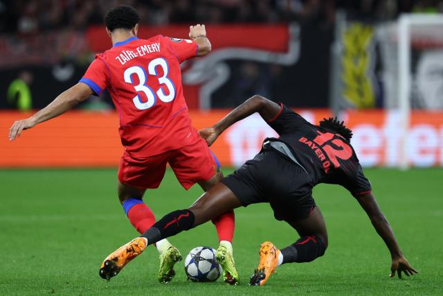 Paris Saint-Germain's French midfielder #33 Warren Zaire-Emery (L) and Bayer Leverkusen's Burkinabe defender #12 Edmond Tapsoba vie for the ball during the UEFA Champions League football match between Bayer 04 Leverkusen and Paris Saint-Germain (PSG) at the BayArena stadium in Leverkusen, western Germany on October 21, 2025. (Photo by FRANCK FIFE / AFP)