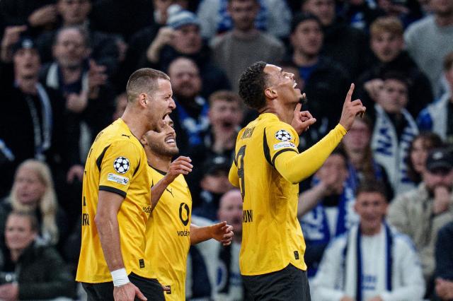 Dortmund's German midfielder #08 Felix Nmecha (R) celebrates scoring his team's first goal during the UEFA Champions League football match between FC Copenhagen and BVB Borussia Dortmund in Copenhagen on October 21, 2025. (Photo by Liselotte Sabroe / Ritzau Scanpix / AFP) / Denmark OUT