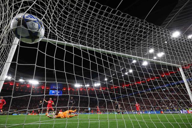 Bayer Leverkusen's Dutch goalkeeper #01 Mark Flekken fails to save the 1-4 goal during the UEFA Champions League football match between Bayer 04 Leverkusen and Paris Saint-Germain (PSG) at the BayArena stadium in Leverkusen, western Germany on October 21, 2025. (Photo by FRANCK FIFE / AFP)
