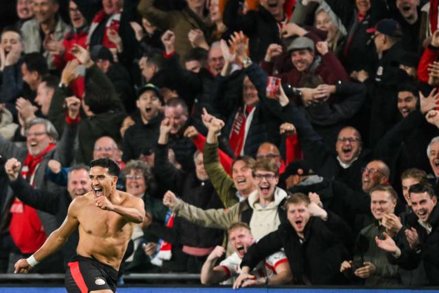 PSV Eindhoven's Dutch forward #11 Couhaib Driouech celebrates after scoring his team sixth goal during the UEFA Champions League, league phase football match between PSV Eindhoven and Napoli at the Philips Stadium, in Eindhoven, on October 21, 2025. (Photo by NICOLAS TUCAT / AFP)
