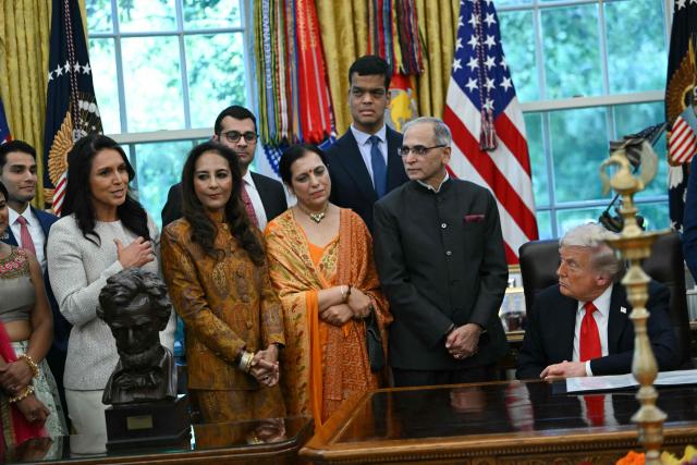 Director of National Intelligence (DNI) Tulsi Gabbard (L) speaks at a Diwali celebration with US President Donald Trump and Indian American leaders in the Oval Office of the White House in Washington, DC, on October 21, 2025. (Photo by ANDREW CABALLERO-REYNOLDS / AFP)