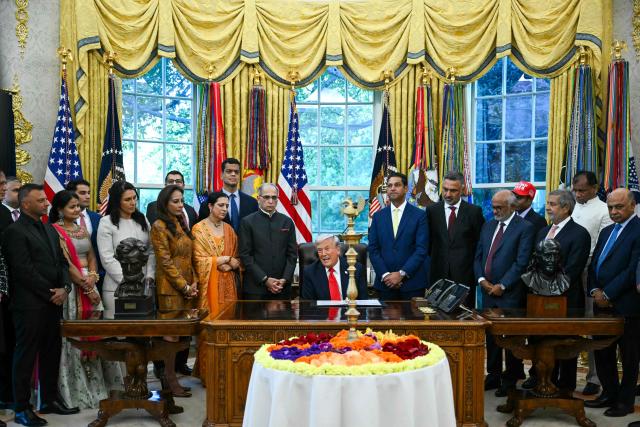 US President Donald Trump (C) hosts a Diwali celebration with Indian American leaders in the Oval Office of the White House in Washington, DC, on October 21, 2025. (Photo by ANDREW CABALLERO-REYNOLDS / AFP)