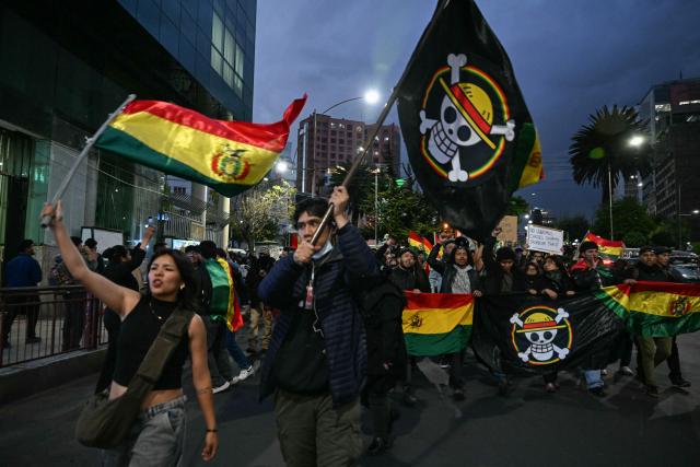 Supporters of Bolivia's former president and presidential candidate for the Freedom and Democracy (Libre) alliance, Jorge "Tuto" Quiroga, hold One Piece manga flags during a protest demanding a vote audit by the Supreme Electoral Tribunal (TSE) following the presidential election, in La Paz on October 21, 2025. Rodrigo Paz, a 58-year-old economist, won the second round of voting on October 19 with 54.5 percent of the votes against former right-wing president Jorge Quiroga. (Photo by AIZAR RALDES / AFP)