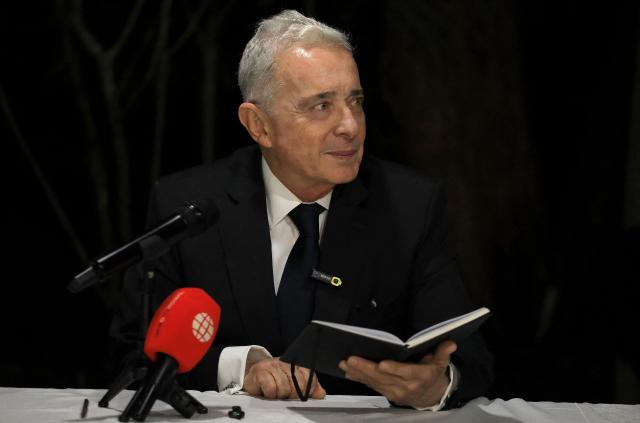 Former Colombian President Alvaro Uribe gestures during a press conference in Rionegro, Antioquia department, Colombia on October 21, 2025. A Colombian court on Tuesday overturned the witness tampering conviction of influential ex-president Alvaro Uribe, who had been sentenced to 12 years' house arrest in a decision condemned by the US. (Photo by JAIME SALDARRIAGA / AFP)