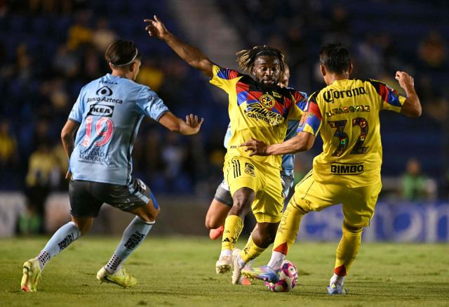 Puebla's forward #19 Ricardo Marin, America's French forward #97 Allan Saint-Maximin and defender #32 Miguel Vazquez fight for the ball during the Liga MX Apertura football match between America and Puebla at the Banorte Stadium in Mexico City on October 21, 2025. (Photo by Yuri CORTEZ / AFP)