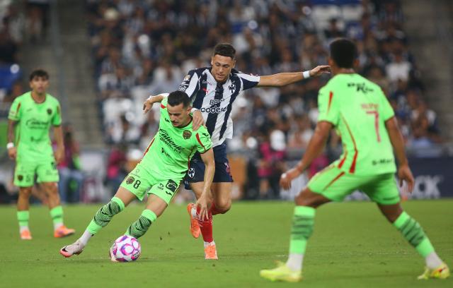 Juarez's Brazilian midfielder #08 Guilherme Castilho and Monterrey's Argentine midfielder #29 Lucas Ocampos fight for the ball during the Liga MX Apertura football match between Monterrey and Juarez at the BBVA Stadium in Monterrey, Mexico, on October 21, 2025. (Photo by Julio Cesar AGUILAR / AFP)