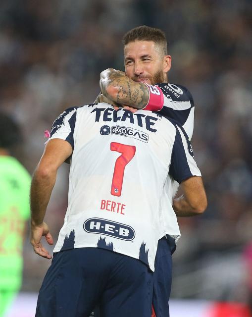 Monterrey's Argentine forward #07 German Berterame celebrates with teammate Spanish defender #93 Sergio Ramos after scoring his team's third goal during the Liga MX Apertura football match between Monterrey and Juarez at the BBVA Stadium in Monterrey, Mexico, on October 21, 2025. (Photo by Julio Cesar AGUILAR / AFP)
