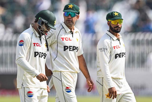 Pakistan's Imam-ul-Haq (L), Asif Afridi (C) and Sajid Khan walk back to the pavilion for lunch break during the third day of the second Test cricket match between Pakistan and South Africa at the Rawalpindi Cricket Stadium in Rawalpindi on October 22, 2025. (Photo by Aamir QURESHI / AFP)