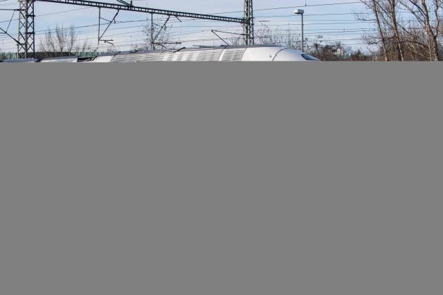 (FILES) Onlookers watch as a new TGV M train, also known as Avelia Horizon, passes by the Bechovice train station in Prague, on its way to the VUZ Velim test centre, on December 7, 2022. Eurostar said on October 22, 2025 it will run double-decker trains through the Channel Tunnel for the first time, as it faces potential competition on its routes between London and mainland Europe. A 2.0-billion euro ($2.3-billion) investment in up to 50 electric double-decker trains built by French group Alstom, with it's Avelia Horizon train, could help Eurostar reach 30 million annual passengers by the new decade, up around 50 percent from current traveller numbers. (Photo by Michal Cizek / AFP)