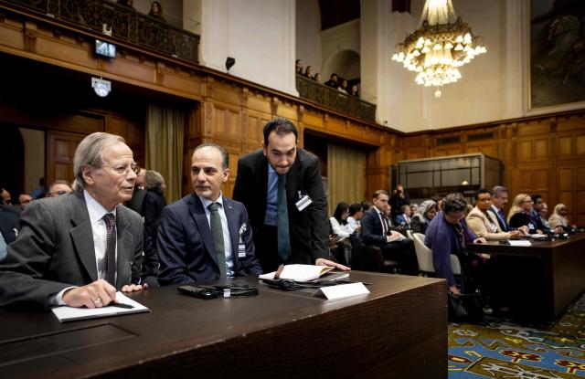 Ambassador and Permanent Representative of the Palestinian Authority to International Organizations in the Netherlands Ammar Hijazi (C) attends the hearing of the International Court of Justice (ICJ) in The Hague on October 22, 2025, to issue an advisory opinion on Israel's obligations to provide assistance in the occupied Palestinian territories. The International Court of Justice said on October 22, 2025 that Israel was obliged to ease the passage of aid into Gaza, stressing it had to provide Palestinians with "basic needs" essential to survival. The wide-ranging ICJ ruling came as aid groups are scrambling to scale up much-needed humanitarian assistance into Gaza, seizing upon a fragile ceasefire agreed earlier this month. The ICJ's "Advisory Opinion" is not legally binding but the court believes it carries "great legal weight and moral authority". ICJ President Yuji Iwasawa said Israel was "under an obligation to agree to and facilitate relief schemes provided by the United Nations and its entities". (Photo by Koen van Weel / ANP / AFP) / Netherlands OUT