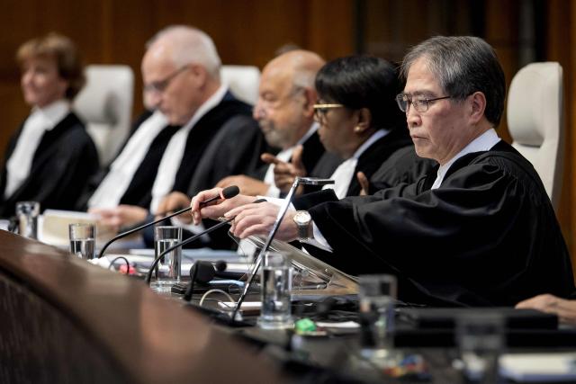 President of the International Court of Justice (ICJ) Yuji Iwasawa chairs the hearing of the ICJ in The Hague on October 22, 2025, in order to issue an advisory opinion on Israel's obligations to provide assistance in the occupied Palestinian territories. The International Court of Justice said on October 22, 2025 that Israel was obliged to ease the passage of aid into Gaza, stressing it had to provide Palestinians with "basic needs" essential to survival. The wide-ranging ICJ ruling came as aid groups are scrambling to scale up much-needed humanitarian assistance into Gaza, seizing upon a fragile ceasefire agreed earlier this month. The ICJ's "Advisory Opinion" is not legally binding but the court believes it carries "great legal weight and moral authority". ICJ President Yuji Iwasawa said Israel was "under an obligation to agree to and facilitate relief schemes provided by the United Nations and its entities". (Photo by Koen van Weel / ANP / AFP) / Netherlands OUT