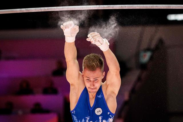 Authorised Neutral Athlete (AIN) Daniel Marinov falls as he competes on the horizontal bar during the men's all-around final at the 53rd FIG Artistic Gymnastics World Championships in Jakarta on October 22, 2025. (Photo by Yasuyoshi CHIBA / AFP)