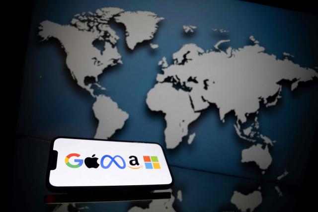 (FILES) This photograph shows logos of the main communication brand also named GAFAM (for Google, Apple, Meta, Amazon and Microsoft) in Mulhouse, eastern France on June 2, 2023. Members of parliament approved on October 22, 2025 in the Finance Committee a tax targeting the 'GAFAM' (Google, Apple, Meta , Amazon, Microsoft), the major American tech companies, which they hope will generate several billion euros. (Photo by SEBASTIEN BOZON / AFP)