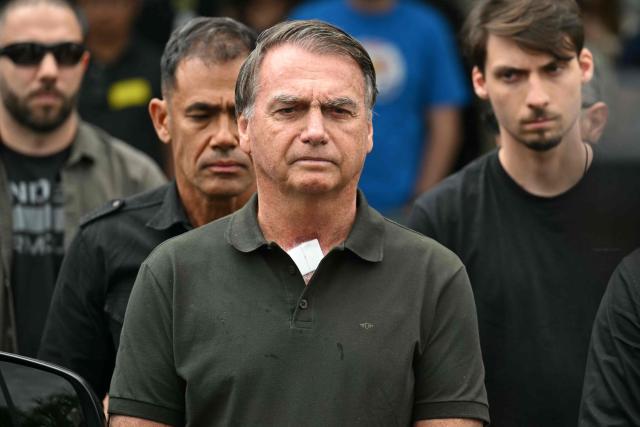 (FILES) Former Brazilian President (2019-2022) Jair Bolsonaro leaves the DF Star hospital accompanied by his son Jair Renan (R) in Brasilia on September 14, 2025, after undergoing a series of medical examinations, as he remains under house arrest. Brazil's Supreme Court on October 22, 2025, handed down a 27-year prison sentence to former President Jair Bolsonaro for attempting a coup d'état. His legal team now has five days to appeal the ruling. (Photo by EVARISTO SA / AFP)