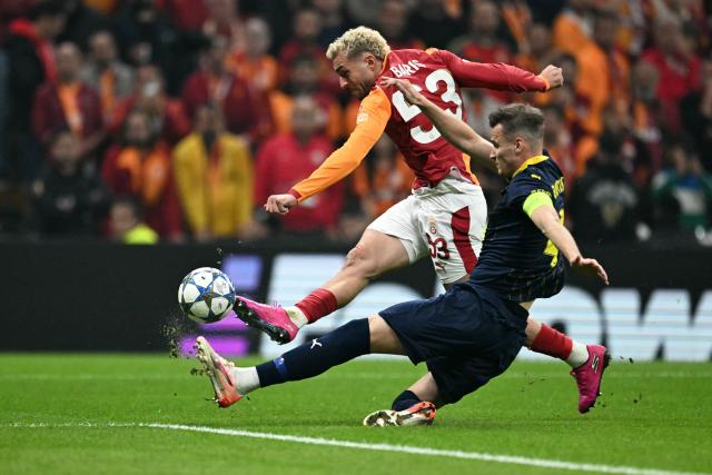 Galatasaray's Turkish forward #53 Baris Alper Yilmaz shoots on tagert next to Bodo/Glimt's Norwegian defender #04 Odin Bjortuft during the UEFA Champions League, league phase - day 3, football match between Galatasaray SK and Bodo/Glimt at the Rams Park in Istanbul on October 22, 2025. (Photo by Ozan KOSE / AFP)