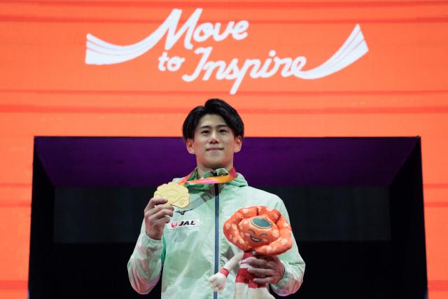 Gold medallist Daiki Hashimoto poses on the podium of the men's all-around final at the FIG Artistic Gymnastics World Championships in Jakarta on October 21, 2025. (Photo by Yasuyoshi CHIBA / AFP)