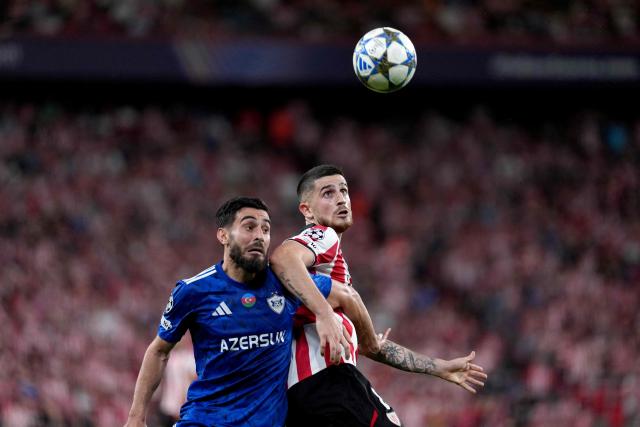 Athletic Bilbao's Spanish midfielder #08 Oihan Sancet fights for the ball with Qarabagh's Azerbaijan defender #44 Elvin Dzhafarquliyev during the UEFA Champions League league phase day 3 football match between Athletic Club Bilbao and Qarabagh at San Mames Stadium in Bilbao on October 22, 2025. (Photo by Cesar MANSO / AFP)