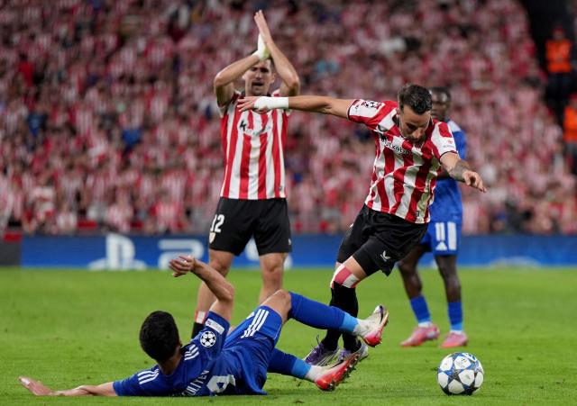 Qarabagh's Azerbaijan defender #44 Elvin Dzhafarquliyev fights for the ball with Athletic Bilbao's Spanish forward #07 Alex Berenguer during the UEFA Champions League league phase day 3 football match between Athletic Club Bilbao and Qarabagh at San Mames Stadium in Bilbao on October 22, 2025. (Photo by Cesar MANSO / AFP)