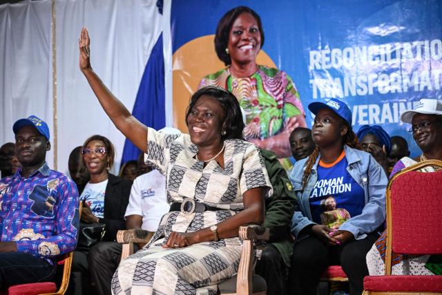 Former Ivorian First Lady and presidential candidate for the Movement of the Capable Generations (MGC), Simone Ehivet Gbagbo (C), greets her supporters before speaking at her campaign rally in Barron, in the working-class commune of Yopougon in Abidjan on October 22, 2025. The presidential election is scheduled for October 25, 2025. (Photo by Sia KAMBOU / AFP)