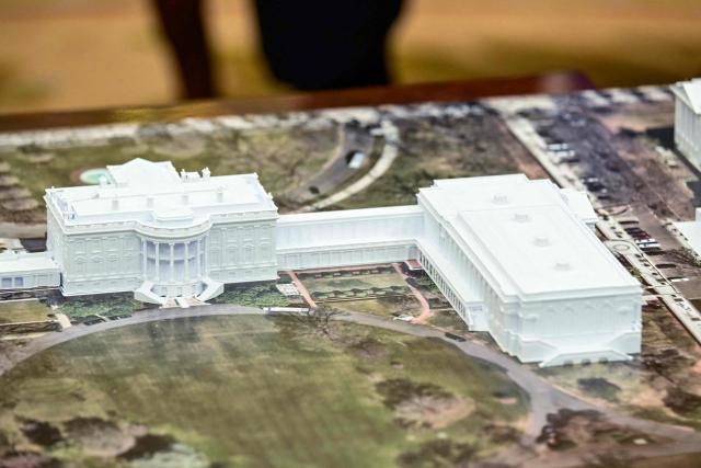 The model of the planned expansion of the White House is seen during a meeting between US President Donald Trump and NATO Secretary General Mark Rutte in the Oval Office of the White House in Washington, DC, on October 22, 2025. (Photo by Jim WATSON / AFP)