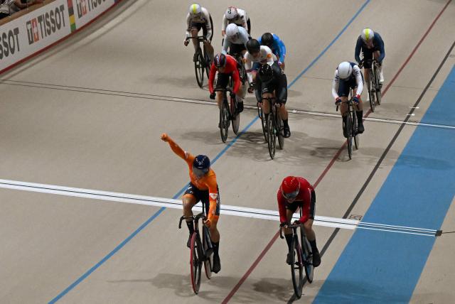 Netherlands' #34 Lorena Wiebes (L) celebrates after winning the women's scratch 10km final during the 2025 UCI Track World Championships at the Peñalolen Velodrome, in Santiago, on October 22, 2025. (Photo by RODRIGO ARANGUA / AFP)