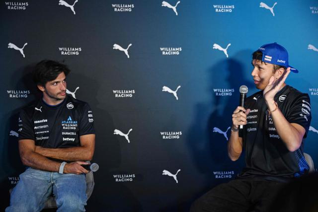 Williams' Thai driver Alexander Albon speaks next to his Spanish teammate Carlos Sainz during a media event in Mexico City on October 22, 2025. (Photo by Yuri CORTEZ / AFP)