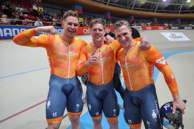 Netherlands' #166 Jeffrey Hoogland, #168 Harrie Lavreysen, and #169 Roy Van der Berg pose for a picture after winning the men's team sprint final during the 2025 UCI Track World Championships at the Peñalolen Velodrome, in Santiago, on October 22, 2025. (Photo by Javier TORRES / AFP)