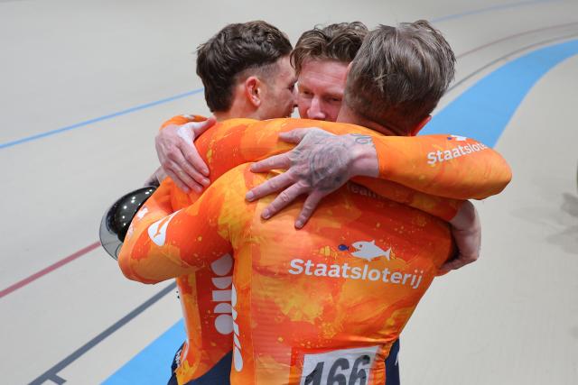 Netherlands'#168 Harrie Lavreysen,  #169 Roy Van der Berg, and #166 Jeffrey Hoogland celebrate after winning the men's team sprint final during the 2025 UCI Track World Championships at the Peñalolen Velodrome, in Santiago, on October 22, 2025. (Photo by Javier TORRES / AFP)