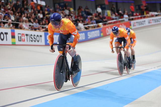 Netherlands' #166 Jeffrey Hoogland, #168 Harrie Lavreysen, and #169 Roy Van der Berg cross the finish line to win the men's team sprint final during the 2025 UCI Track World Championships at the Peñalolen Velodrome in Santiago on October 22, 2025. (Photo by Javier TORRES / AFP)