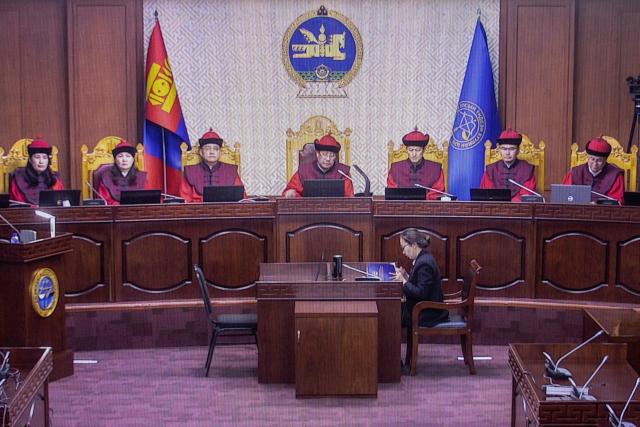 This picture taken from a screen outside the courtroom of Mongolia's Constitutional Court on October 22, 2025 shows a live broadcast of lawmakers during a session where they discussed the removal of prime minister Gombojav Zandanshatar in Ulaanbaatar. Mongolia's constitutional court rejected a parliamentary attempt to remove the prime minister as invalid on October 22, potentially deepening the country's political crisis. (Photo by Byambasuren BYAMBA-OCHIR / AFP)