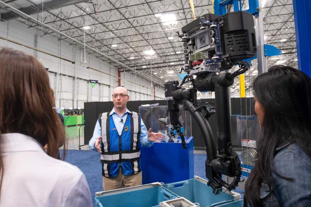 Igor Pedan, with Amazon Roobotics, introduces Blue Jay, Amazon’s latest robotic system, during Amazon's "Delivering the Future" presentation at DUR3 Delivery Station in Milpitas, California on October 22, 2025. (Photo by Laure Andrillon / AFP)