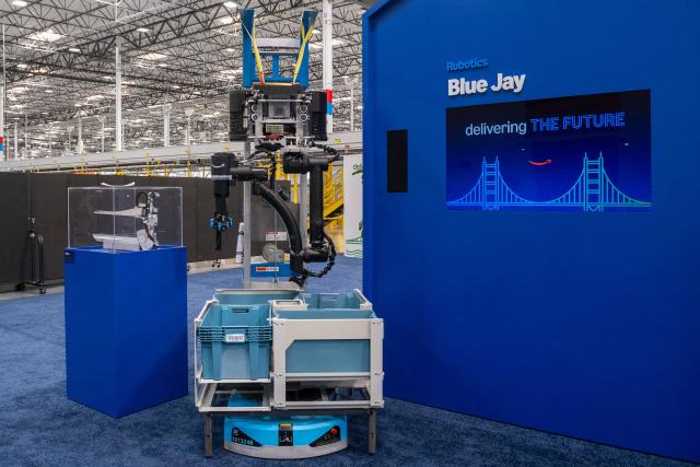 Amazon's latest robotic system Blue Jay is displayed during Amazon's "Delivering the Future" presentation at DUR3 Delivery Station in Milpitas, California on October 22, 2025. (Photo by Laure Andrillon / AFP)