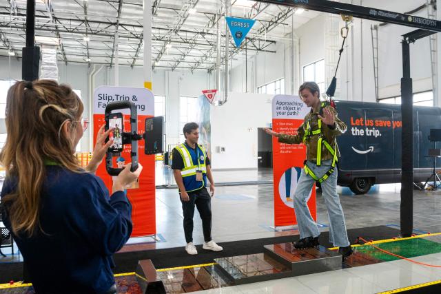People participate in a slip, trip, and fall simulation training during Amazon's "Delivering the Future" presentation at DUR3 Delivery Station in Milpitas, California on October 22, 2025. (Photo by Laure Andrillon / AFP)