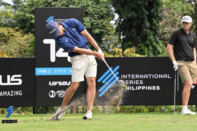 Hong Kong's Matthew Cheung (L) plays a shot during the International Series Philippines golf tournament at Sta. Elena Golf Club in Santa Rosa, Laguna province on October 23, 2025.  (Photo by Ted ALJIBE / AFP)