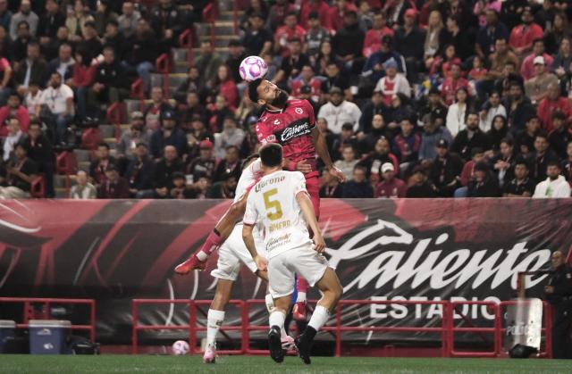 Tijuana's Spanish forward #21 Mourad El Ghezouani (top), Toluca's defender #02 Diego Barbosa and Argentine forward #05 Franco Romero fight for the ball during the Liga MX Apertura football match between Tijuana and Toluca at Caliente Stadium in Tijuana, Mexico, on October 22, 2025. (Photo by Guillermo Arias / AFP)